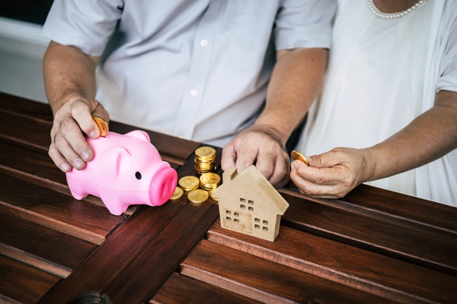 Elderly couples talking about finance with piggy bank placeholder